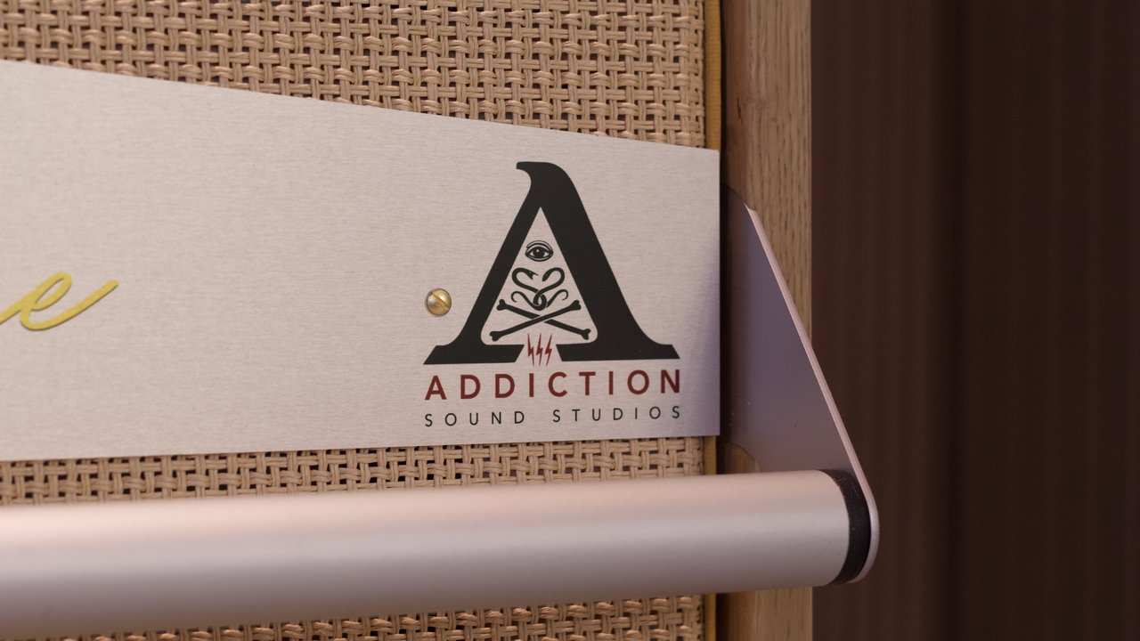 Close view of a custom studio logo printed onto the brushed aluminium sign