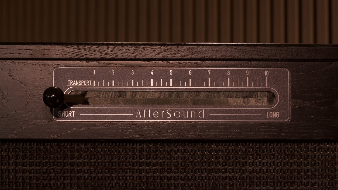 Close-up of the Reverbophone's mechanical decay lever, marked Short to Long, set into an oak cabinet edge.