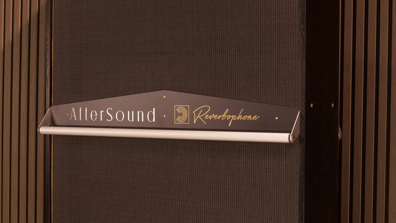 The black AfterSound and Reverbophone sign above the decay lever on a black grille, flanked by slatted timber walls